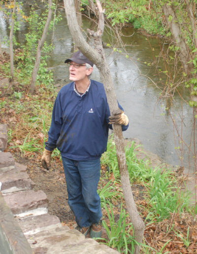 Mike Sellers retrieves a large branch from the banks of the creek.